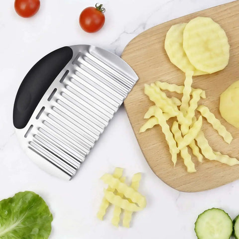 Stainless Steel Potato Crinkle Cutter And French Fry Cutter Large Wavy Slicer For Vegetables And Fruits Must Have Dope Durable Kitchen Chopping Tool For Potatoes Carrots Onions And More Black on a cutting board with crinkle cut potatoes