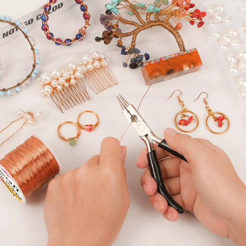 Hands using 4-in-1 pliers on copper wire jewelry making kit with beads and crafted items, including earrings and hairpins.