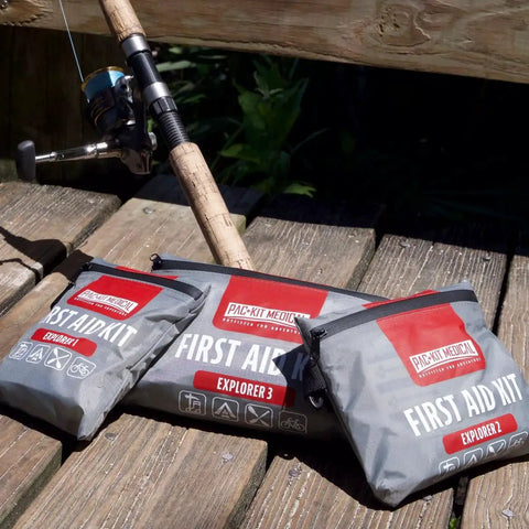 Watertight Explorer 67-Piece Outdoor First Aid Kit for Hiking and Camping shown on wooden dock