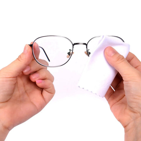 Cleaning eyeglasses with a white cloth from the 10 Pack Microfiber Cleaning Cloths 7x6 Inch For Phones Tablets Laptops Glasses