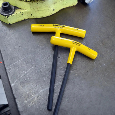 Close-up of dual yellow-handled hex keys from Ten Piece Hex T Handle Set With Stand Includes Sizes 3/32 Through 3/8 Inch Cushioned Ergonomic Grip Pro Grade Tools Built Tough Made In The USA For Pro Techwork And Home Repairs.