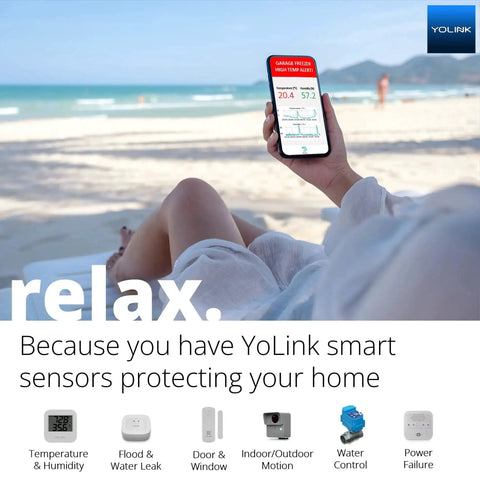 Person on beach using phone with smart home app, showcasing LoRa Long Range Indoor Motion Detector With One Quarter Mile Coverage.
