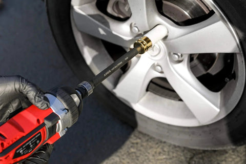 Foot/Pound Torque Limiting Extension Bar - Chrome Moly 1/2-Inch Drive 8-Inch Long Impact Grade Bar - Flex Action Prevents Over-Tightening - Color Coded for Easy Identification being used on a car wheel lug nut.