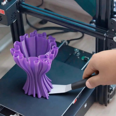 Hand using Beefy Dual Edge 3D Printer Scraper Kit With Curved And Straight Blades on 3D print model