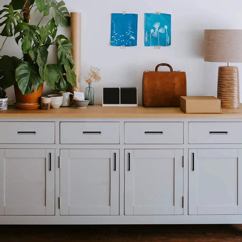 White cabinet with 30 Pack Solid 5 Inch Square Cabinet Handles Matte Black Pulls for kitchen cabinets and drawers installed.