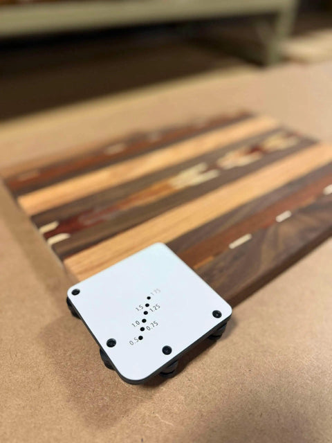 Must Have Cutting Board Foot Jig For Woodworking That Delivers Fast Precise Marking Drilling Or Punching One Eighth Inch Holes With A Heavy Duty 7mm Phenolic Locating Plate Built To Last on a wooden surface