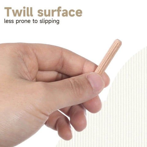 Hand holding a 1/4 x 1-1/2 inch wood dowel pin, highlighting fluted surface for the 100 Count 1/4 Inch Wood Dowel Pins product.