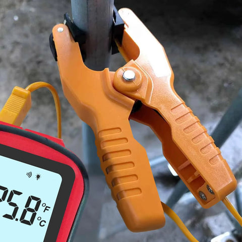 JuviPerpric digital K-type dual-channel thermometer with two orange clamp probes and wired thermocouples clamped to a pipe.