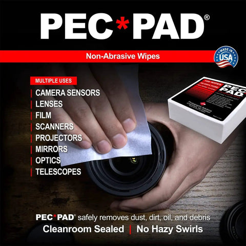 Hand using PEM-PAD lint free 4x4 wipes for camera lenses, showing packaging and wipe on lens surface, non-abrasive optics cleaning.