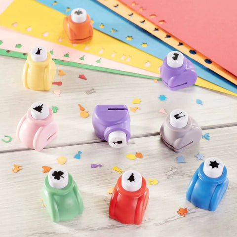Mini Scrapbook Paper Hole Puncher Set With Forty Holiday Designs featuring colorful punchers and paper confetti on a table