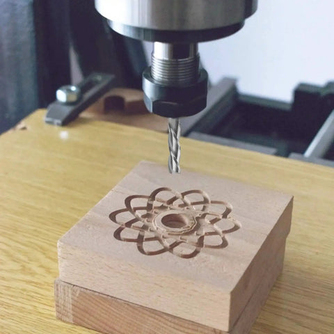 Upcut Spiral Router Bit With Half Inch Shank And Half Inch Cutting Diameter For Wood Mortises Carving And Engraving, Four Inch Overall Length And Two Inch Cutting Length, Pro Grade Carbide CNC End Mill For Serious Woodworking in action on CNC machine, carving intricate design into wood block.