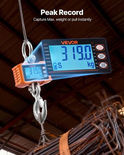 Beast Of A Digital Crane Scale With 4400 Lbs Capacity, LCD display reading 319 kg, hanging from a hook, in industrial setting.