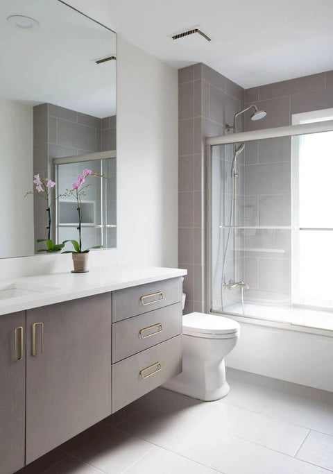 Modern bathroom with gray cabinets featuring Champagne Bronze Cabinet Pulls With Center Hole 5 Inch Length for drawers and cupboards.