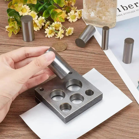 Five Piece Disc Cutter Set With Five Round Punch Sizes One Half Inch, Five Eighths Inch, Three Quarters Inch, Seven Eighths Inch, And One Inch for jewelry making, shown on table.