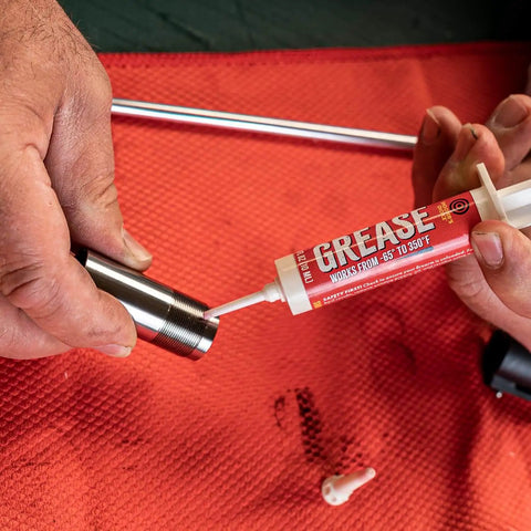 All Weather Synthetic Grease For Firearms High Tech Lubricant That Clings In Extreme Heat Or Cold in a 10cc syringe being applied