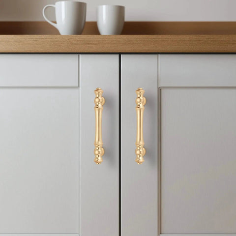 Brushed Brass Cabinet Handles 10 Pack 3 Inch Hole Centers Zinc Gold Drawer Pulls installed on white kitchen cabinet doors