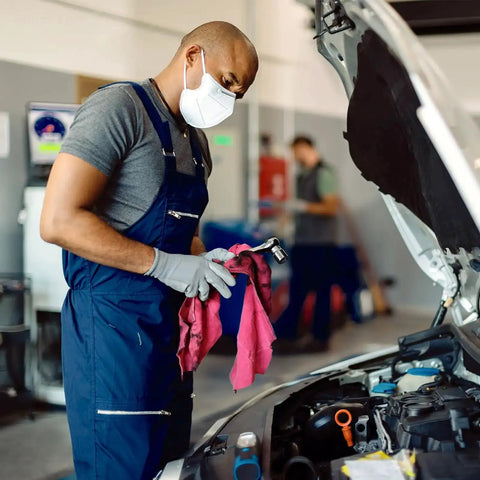 Mechanic using Recycled Multipurpose Industrial Wiping Cloths 49 Lb Pack Assorted Colors Eco Friendly Cleaning Rags in auto shop