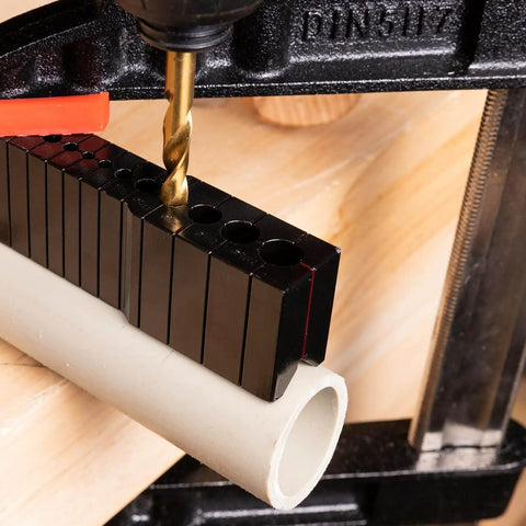 Precision Drill Guide For Straight Holes Compact Portable Drilling Block for wood, metal, and plastic, shown on a pipe.
