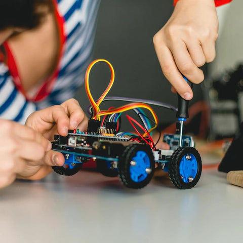 Young person assembling a robotic car using the Metric Screw Set 1760Pcs M2 M3 M4 M5 Hex Socket Head Cap Bolts Nuts Grade 12.9.