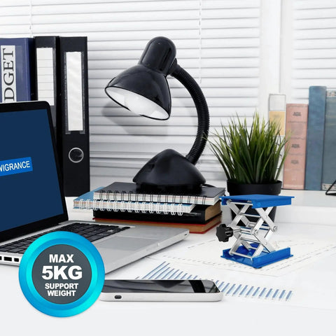 Desk setup with 2 Pack Lab Jack Stands 4x4in Aluminum Lifting Platform 5kg Capacity holding items next to a lamp.