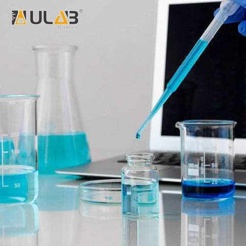 ULAB sterile transfer pipette, 3 ml LDPE, lab scene with blue liquids in beakers