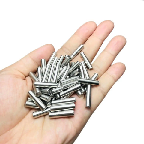 Hand holding 52-Piece 5mm x 20mm Dowel Pins Stainless Steel 304 Shelf Pegs for Wood Furniture and Beds M5 Pins