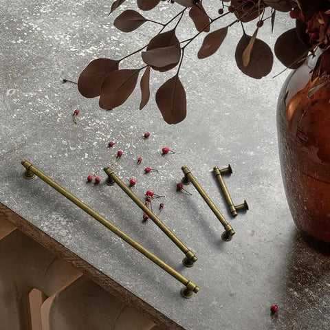 Vintage Brass Cabinet Handles Set Of 6 With 128mm Hole Center Striped Design on a textured surface beside a decorative vase.