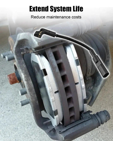 Front brake pad wear sensor with black wiring harness attached to a silver brake caliper and rotor