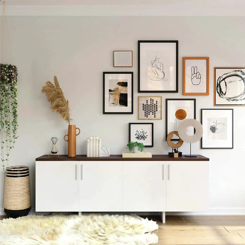 Modern living room with white cabinet, framed art, plants, and decor pieces on a shelf
