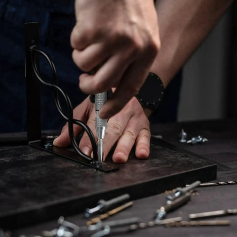 Person using Spring Loaded Center Punch Marker For Wood Metal Plastic With Palm Cushion Cap 5 Inch Automatic Scriber Tool on metal surface.