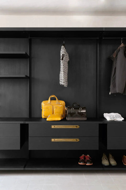 Closet with drawers featuring antique brass zinc alloy cabinet handle with backplate and bags for visual context.