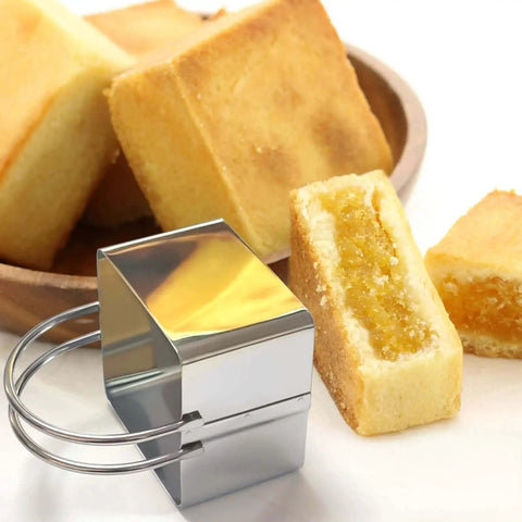 Close-up of a Five Piece Stainless Steel Biscuit Cutter Set With Handle For Easy Square Cookie Shaping And Cake Decorating Includes 4 5 6 7.5 And 8 Cm Cutters Made From 18 8 Stainless Steel Durable Rust Resistant For Bakers Who Bake Like A Pro From ALLTOP beside square baked cookies.