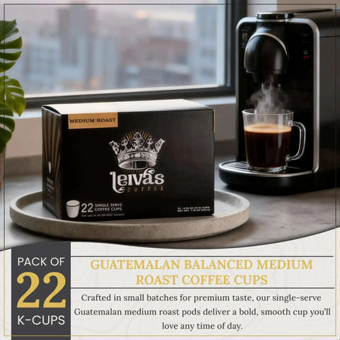 Box of Guatemalan Single Serve K Cups Coffee Pods 22 Count Medium Roast next to a Keurig coffee maker brewing coffee.