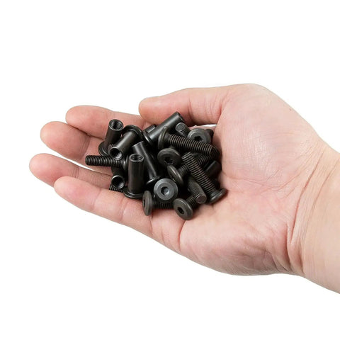 Hand holding 50 Pcs M6x25mm Furniture Bolts Black Hex Screws And Barrel Nuts Kit Binding Post Screws for bunk bed hardware.
