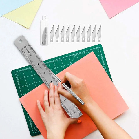 Hands using 28 Piece Precision Craft Tools Set For Vinyl Weeding And DIY Art Projects including ruler and cutting knife on board