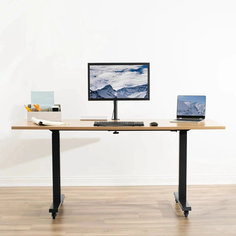 Standing desk with monitor and laptop on one and a half inch swivel caster wheels with brakes for mobility.