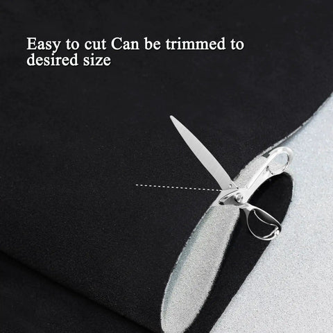 Close-up of Suede Headliner Fabric With Foam Backing For Car Interior Black 96x60 being cut with scissors.