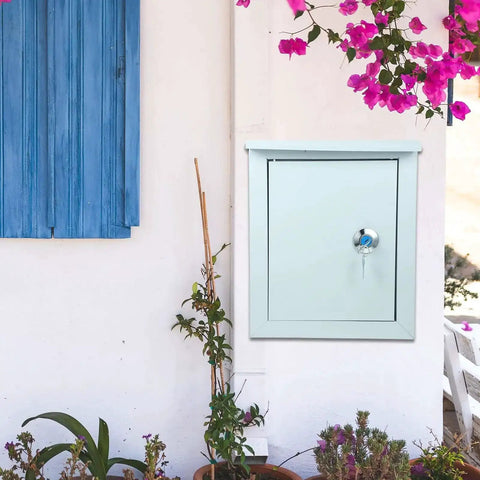 Tough As Nails Outdoor Waterproof Junction Box For Low Voltage Circuits installed on outdoor wall next to blue window