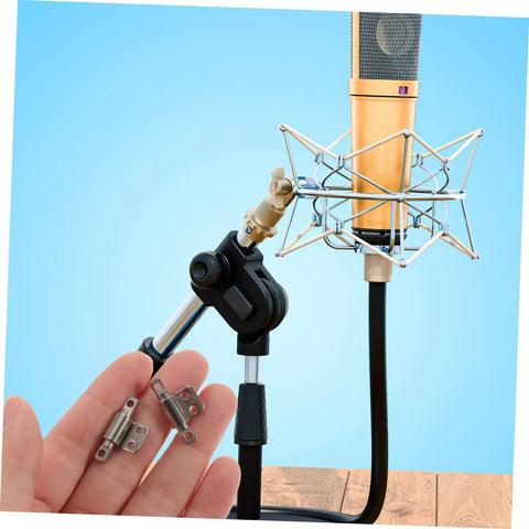 Person holding miniature torque damping hinges 2 pack beside a studio microphone stand with visible mounting applications.