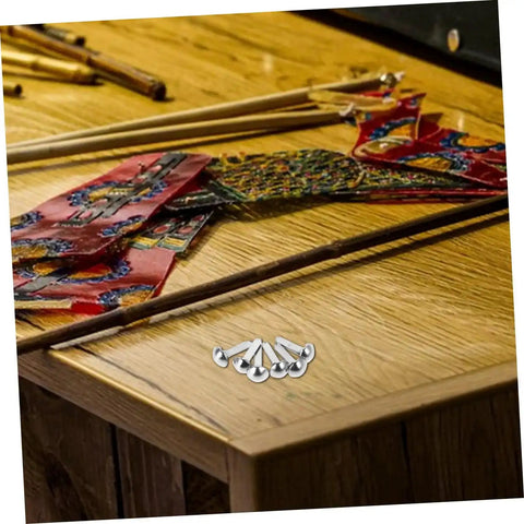 100 Pcs Diy Iron Brads For Puppet Making Kit Mini Fasteners for kids crafts on a wooden table with colorful materials.
