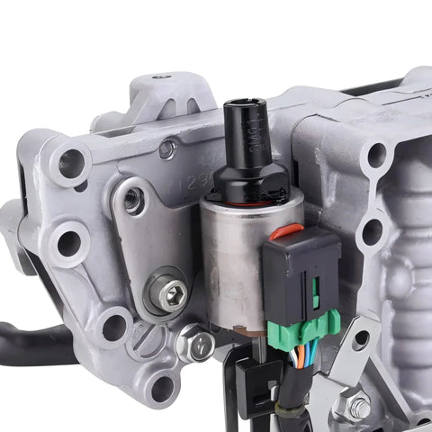 Automotive CVT transmission stepper motor mounted on a silver metal housing with a black drive shaft, orange tab, and green electrical connector.