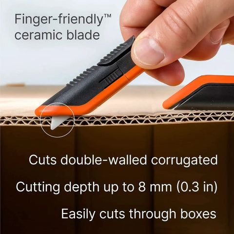 Close-up of 3 Position Box Cutter With Ceramic Zirconia Blade and Locking Blade cutting cardboard. Focus on safety and precision cut.