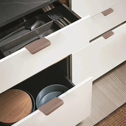 Image of Finger Edge Pulls Self-Adhesive 8 Pack Concealed Cabinet Drawer Handles Modern Curved Aluminum Alloy, brown, installed on white drawers.