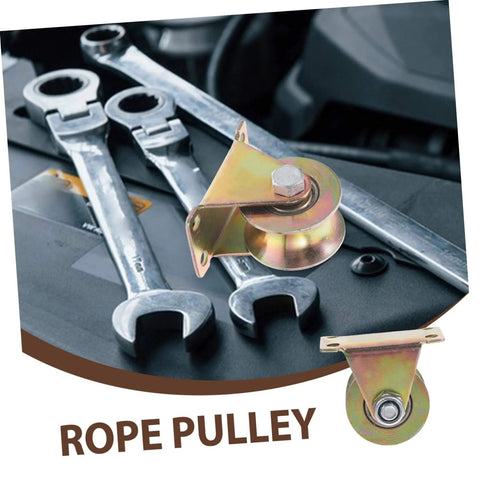 Rope pulley with three wrenches on a dark surface, metallic finish. Pulley features durable steel construction and mounting bracket.