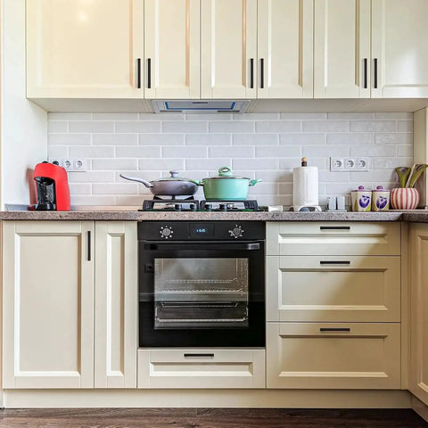 Modern kitchen with 30 Pack Solid 3-1/2 Inch Square Cabinet Handles In Oil Rubbed Bronze and cream cabinets.
