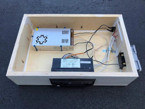 Interior view of a speaker enclosure showcasing Dope Four Pin Four Position Speaker Terminal Blocks With Spring Loaded Push Release Clamp Test Clips For Stereo Speakers Pack Of Four Black Plastic Copper Connectors