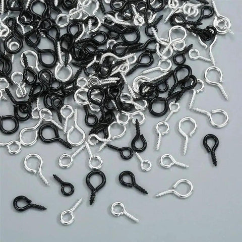 Must Have 300Pcs Small Screw Eye Pins For Jewelry Making And DIY Crafts in silver and black, three sizes scattered on a surface