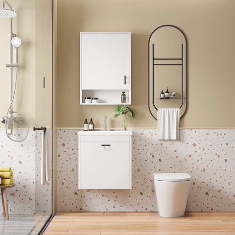 Modern bathroom interior with wall cabinet, round mirror, shower, and terrazzo tiles.
