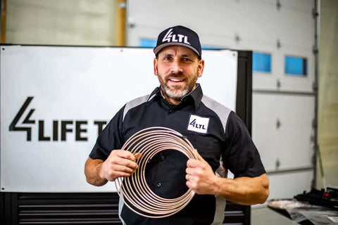 Man holding Copper Nickel Brake Line Coil 1/2 Inch By 25 Foot Non Magnetic Tubing For Automotive Use, Easy Bend and Flare