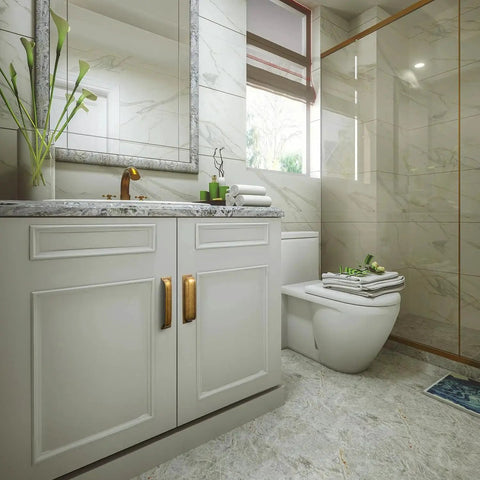 Modern bathroom with marble tiles and cabinets featuring antique brass cup pulls, showcasing elegant design and functionality.